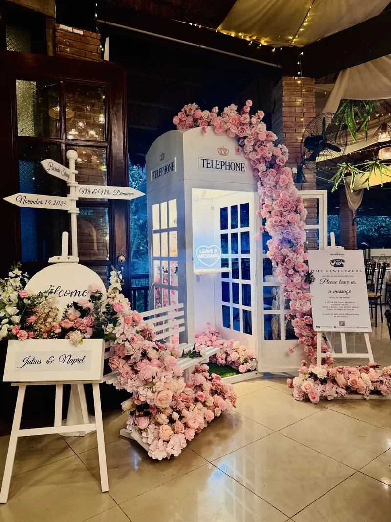 Close view of The Memorings booth framed with florals